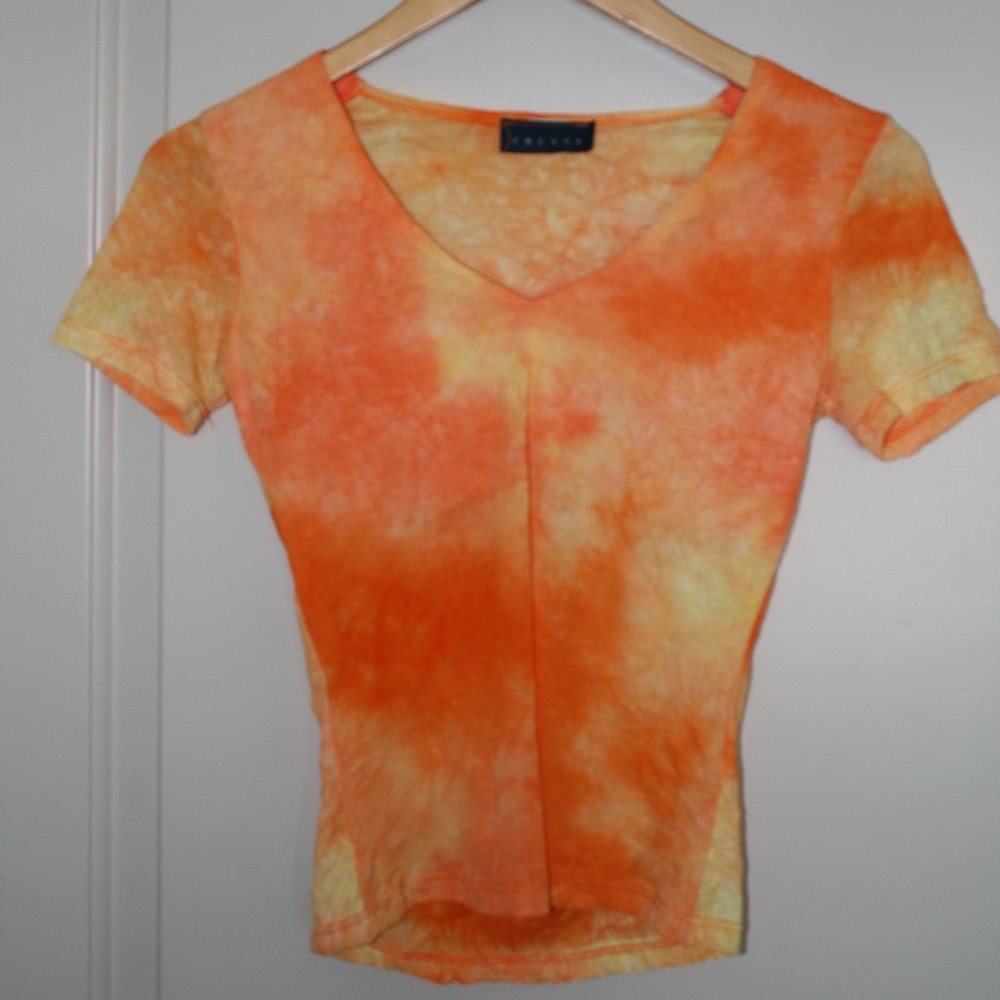 Blouse color orange, not harsh on skin, love how it looks with denim!